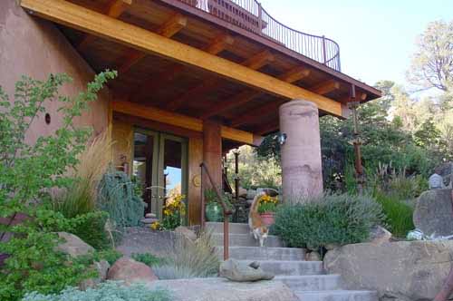 Front entry to a Poured Earth home in Prescott, Arizona, with family cat on the steps